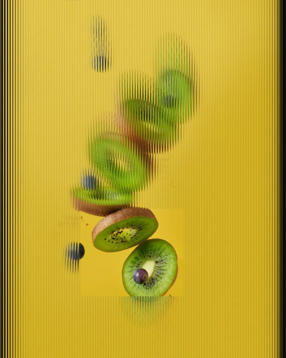 Fluted glass over a kiwi on a table, with a clear rectangular window showing sharp fruit.