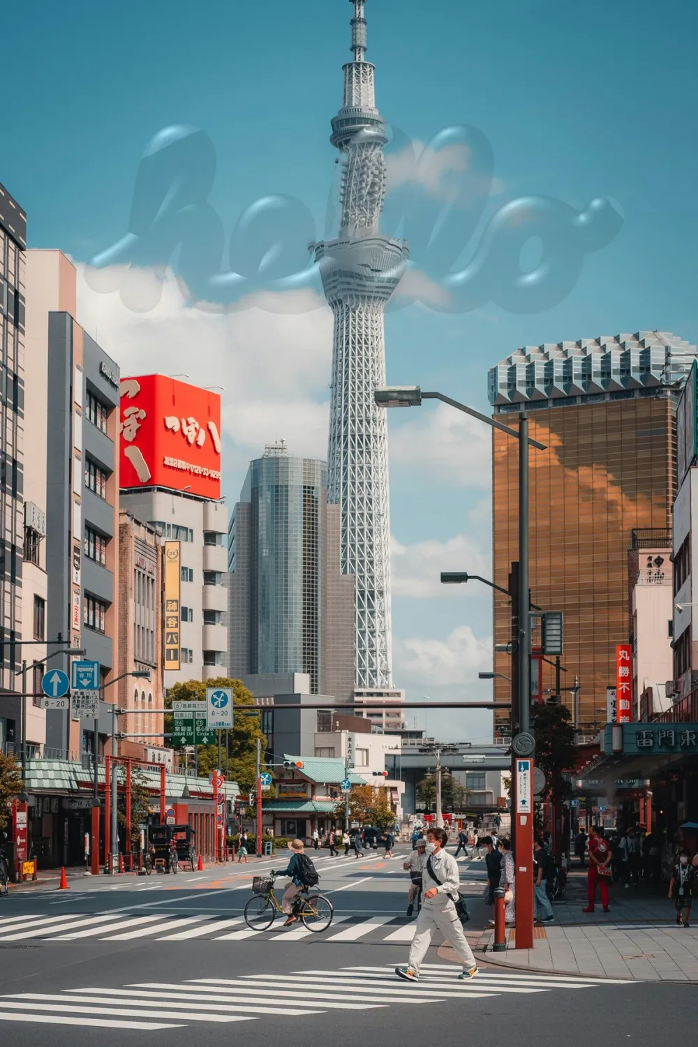 A Tokyo street with Tokyo Skytree in the background and the word hello in clear glass letters floating in the sky.